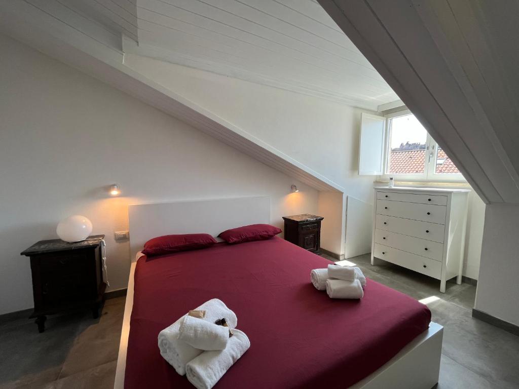 a bedroom with a large bed with towels on it at Suite The Roof in Turin