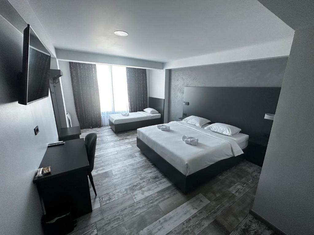 a hotel room with two beds and a flat screen tv at Super SAN in Posušje