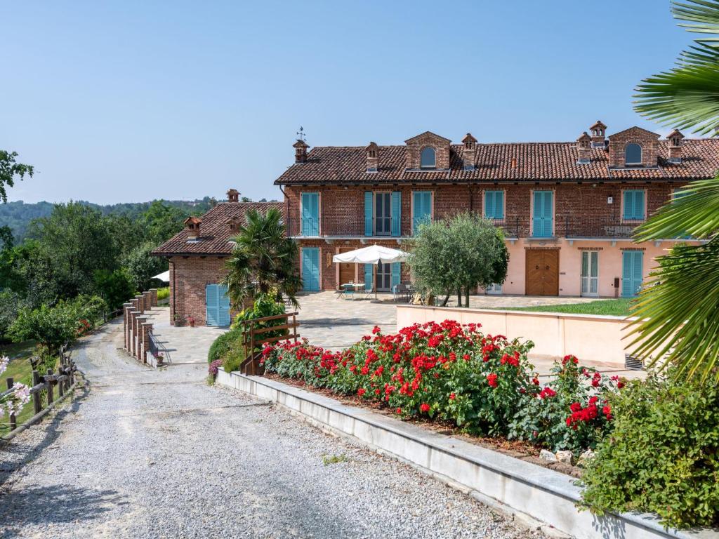 a house with red flowers in front of it at Holiday Home Bricco delle Rondini by Interhome in Villata