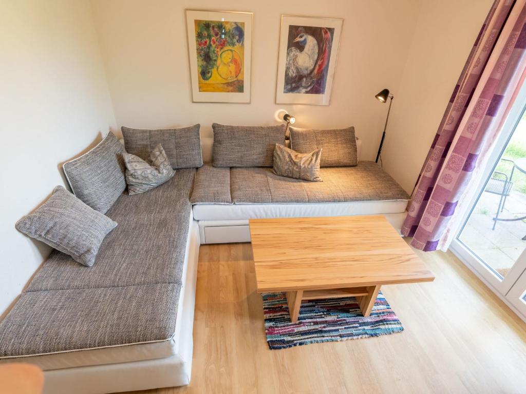 a living room with a couch and a table at Holiday Home Uhu by Interhome in Dittishausen