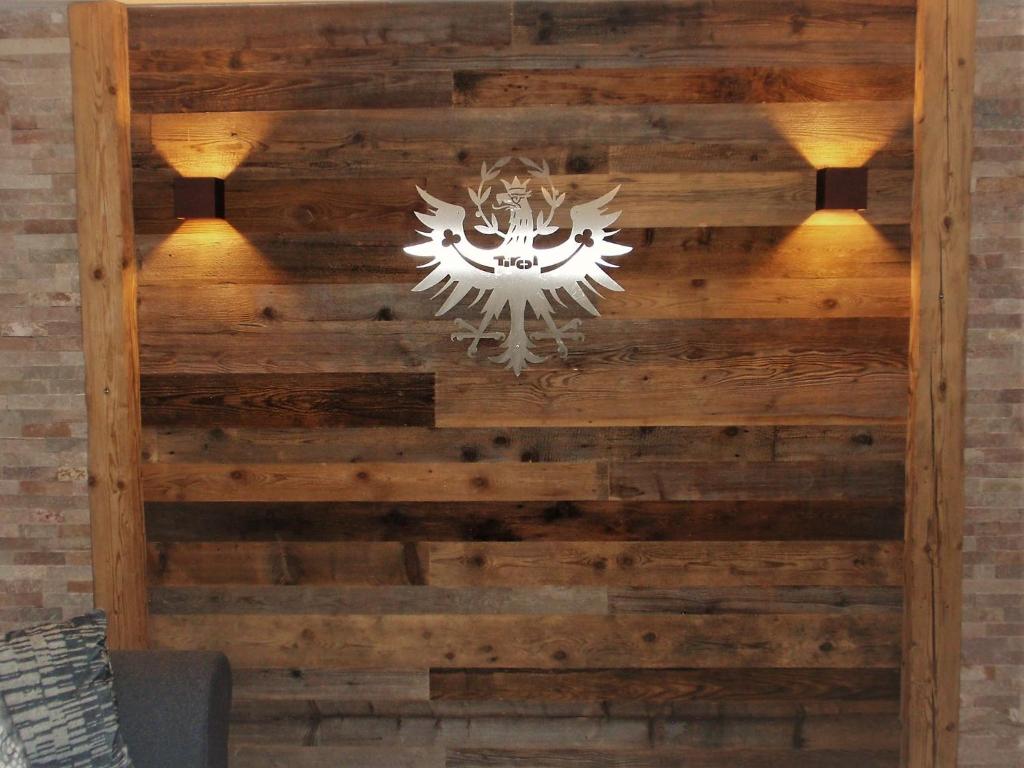 a wooden wall with a chandelier on it at Sellraintaler Auszeit 1 in Sellrain