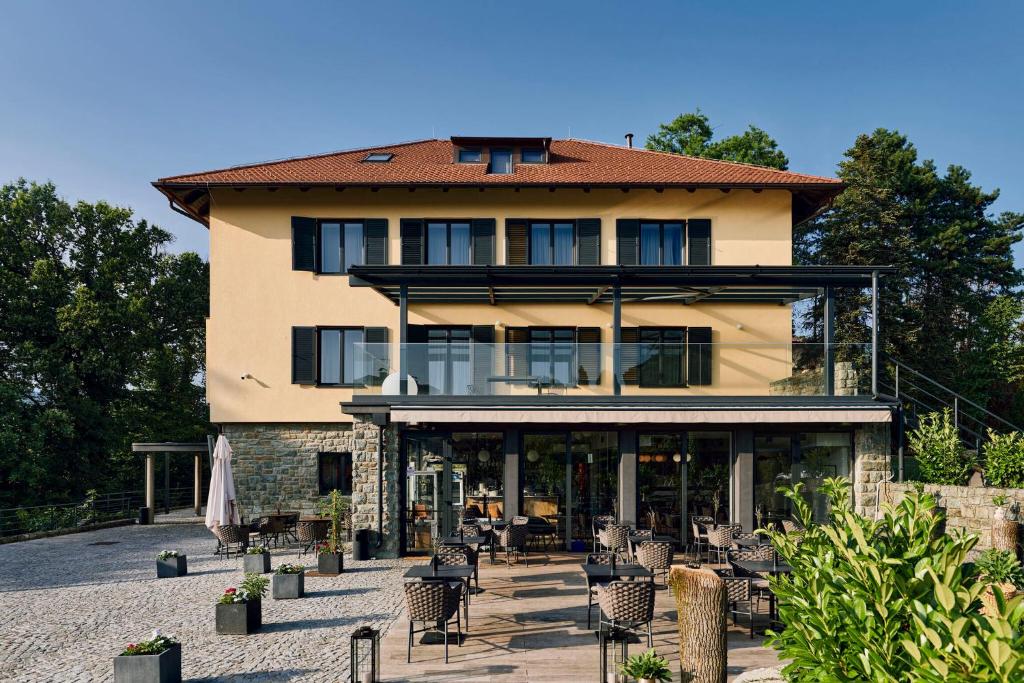 a large building with tables and chairs in front of it at Hotel REPUBLIKA in Zagreb