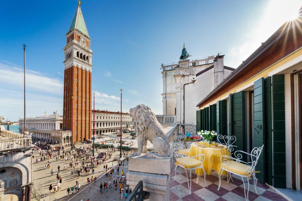eine Stadt mit einer Löwenstatue und einem Uhrturm in der Unterkunft Due Leoni Terrace In St Mark's Square in Venedig