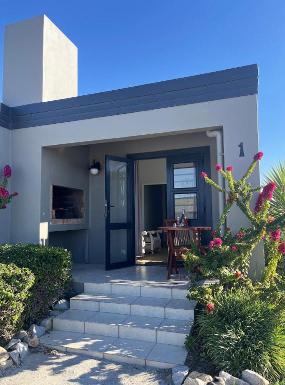 a house with a porch with a patio at Accommodation @Sea Trader in St. Helena Bay