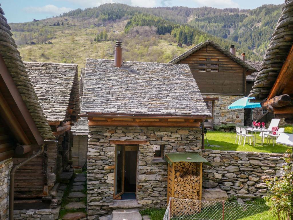 an old stone house with a view of the mountains at Holiday Home Rustico La Dimora by Interhome in Malvaglia