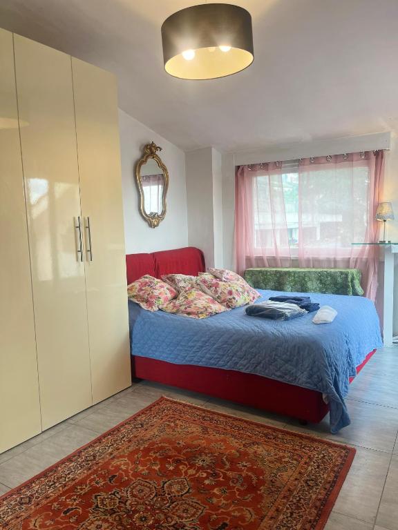 a bedroom with a bed and a cabinet and a rug at Apartment in Roma with Terrace in Rome