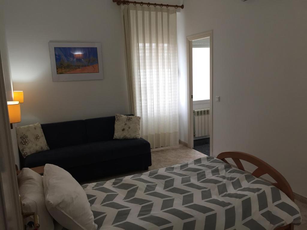 a living room with a bed and a couch at Pension Subirats Perello in Perelló