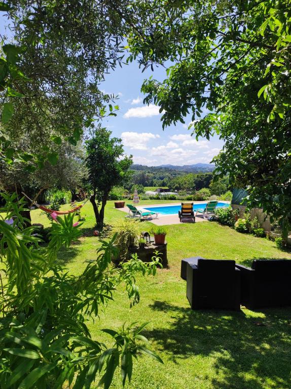 a view of a yard with a swimming pool at Casa Matreiro in Proselo