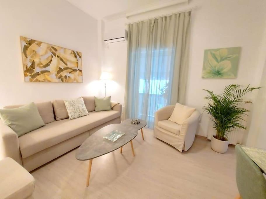un soggiorno con divano e sedia di Keramikos at Plateon central Athens apartment by SuperHost Hub ad Atene