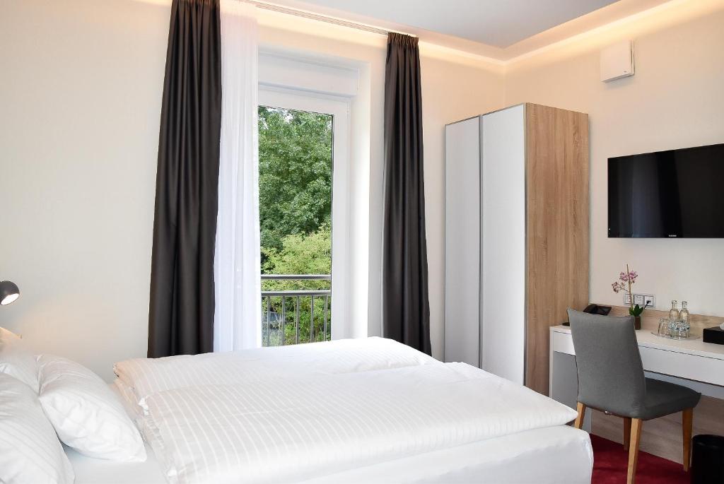 Postel nebo postele na pokoji v ubytování Hotel am Waldkasino