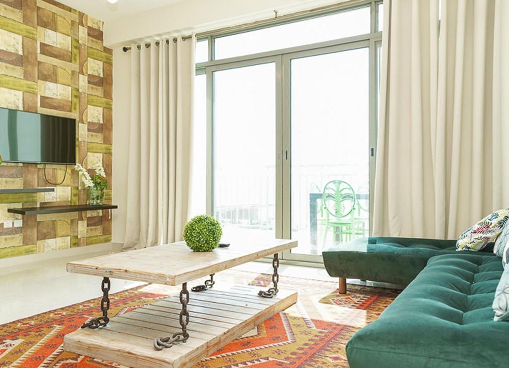 a living room with a couch and a table at RH- Escape to Golf View, 03BR with large Terrace, Greens in Dubai
