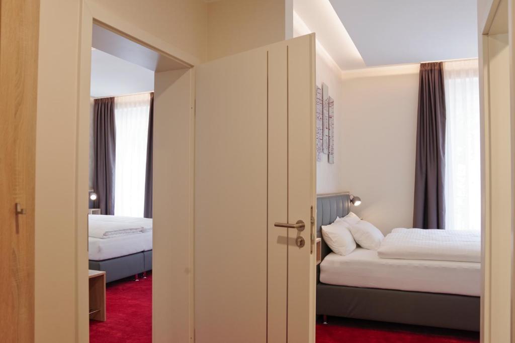 Postel nebo postele na pokoji v ubytování Hotel am Waldkasino