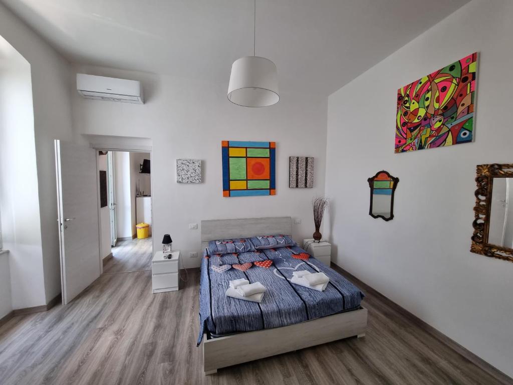 a bedroom with a bed and paintings on the wall at THE GALLERY in La Spezia