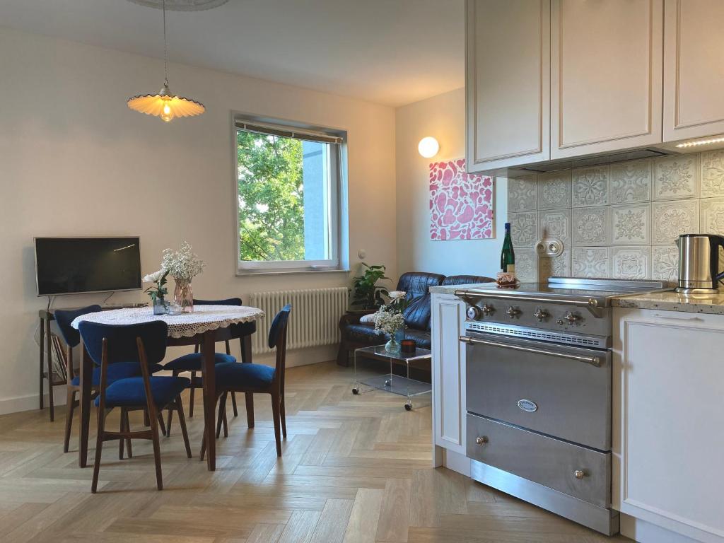 a kitchen and dining room with a table and a dining room at Retro Apartment Iława in Iława