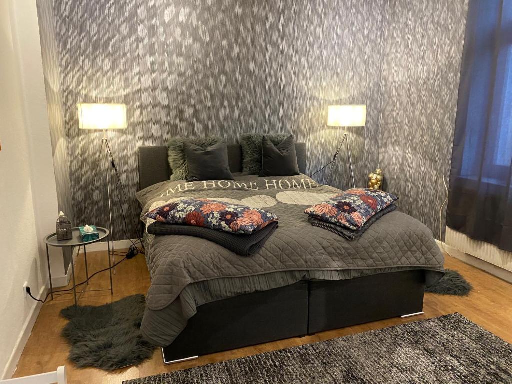 una camera con un grande letto con due lampade di Appartment First a Duisburg