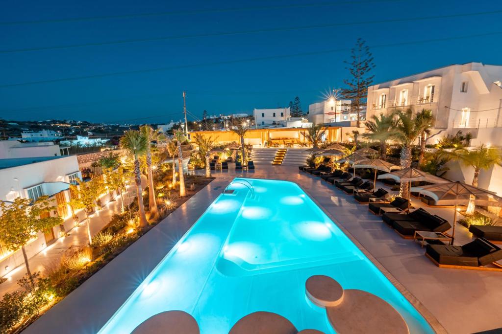 a pool on the roof of a hotel at night at Akkadian LGBT Only Boutique Hotel in Mikonos
