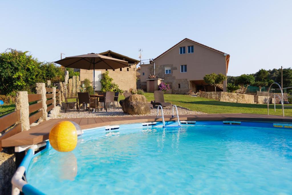 a swimming pool with a yellow ball in the water at A Casa De Lucha in Meis