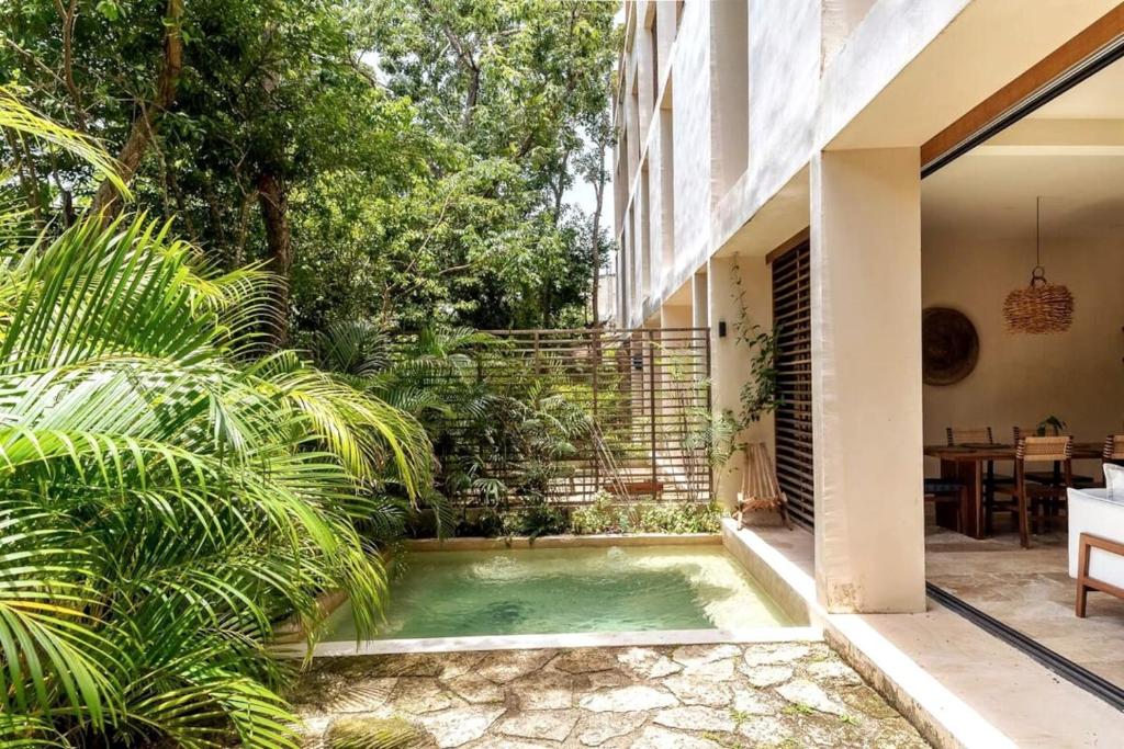 a small pool in the courtyard of a house at Bai-Ha Luxury 103 in Tulum