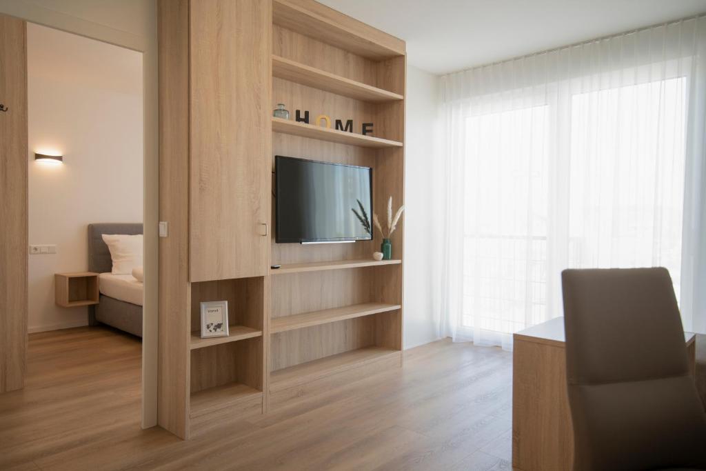 TV a/nebo společenská místnost v ubytování Smart & Stay Aparthotel Saarlouis Lisdorf - Self-Check-In - Free Parking