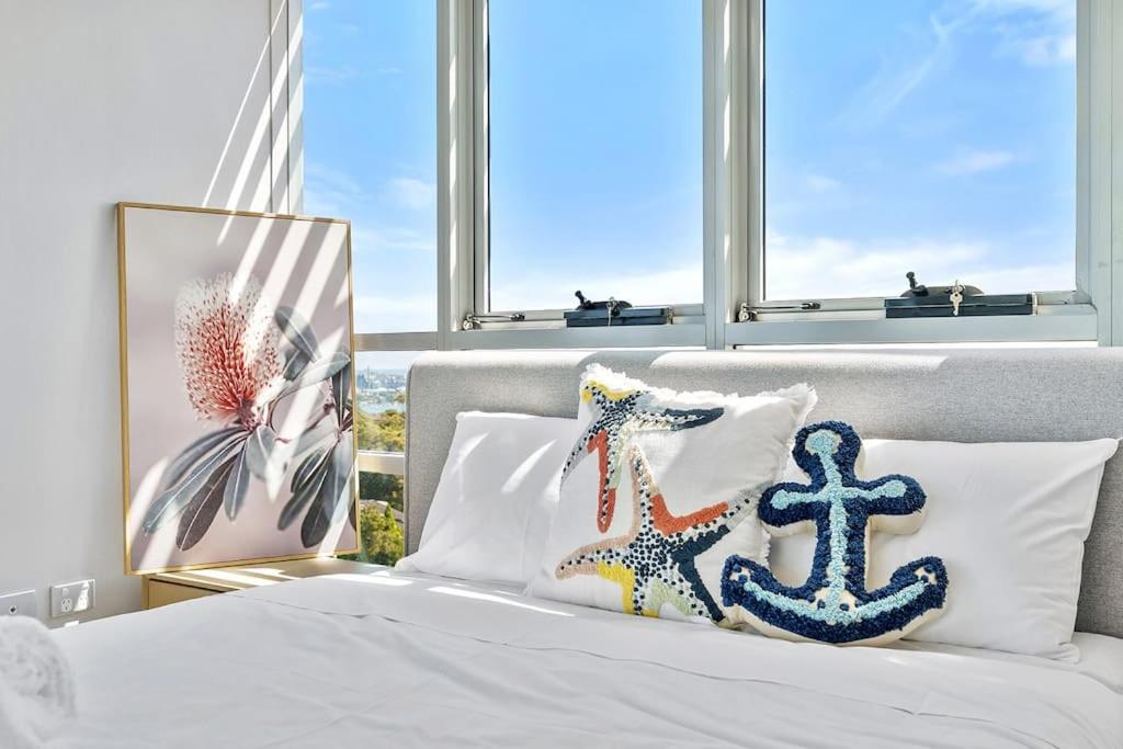 a bedroom with a bed with a anchor pillow at Iconic Sydney Harbour Bridge view in Sydney