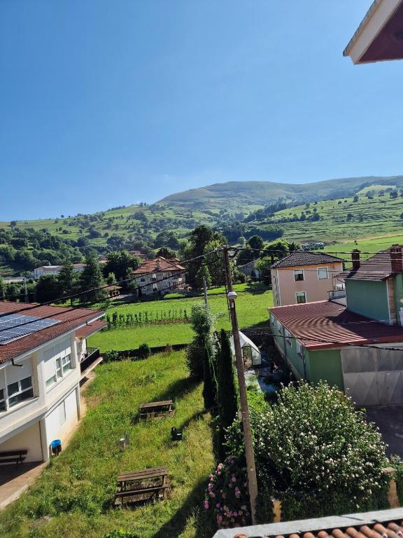 a view of a small town with a green field at APARTAMENTO SUJARRERA in Villacarriedo