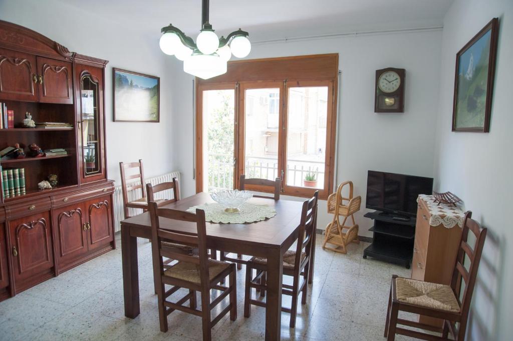 comedor con mesa de madera y sillas en Ca l'Armengol Rooms en Balaguer