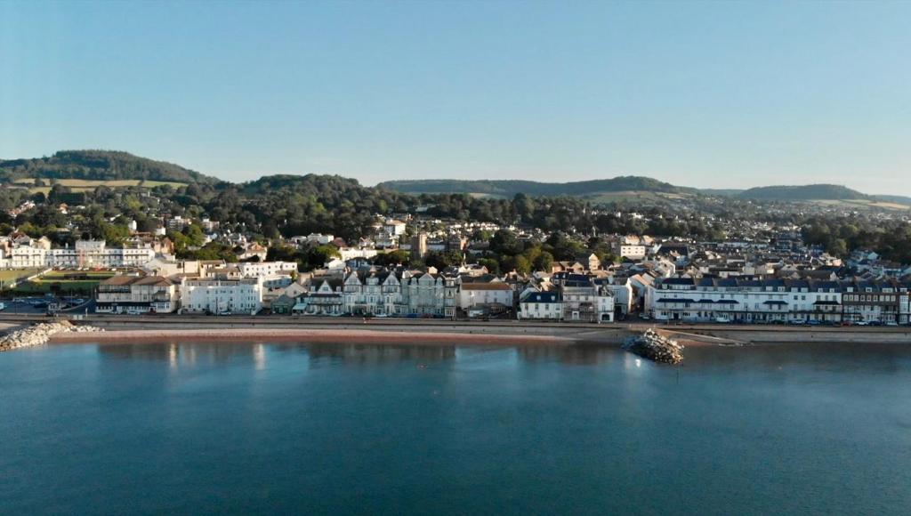 a view of a city with a beach and buildings at The Elizabeth in Sidmouth