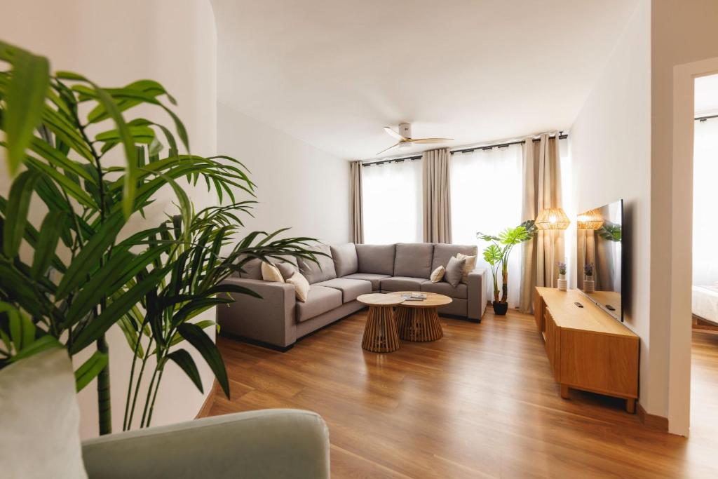 a living room with a couch and a table at Bravissimo Figuerola, Spacious 3-bedroom apartment in Girona