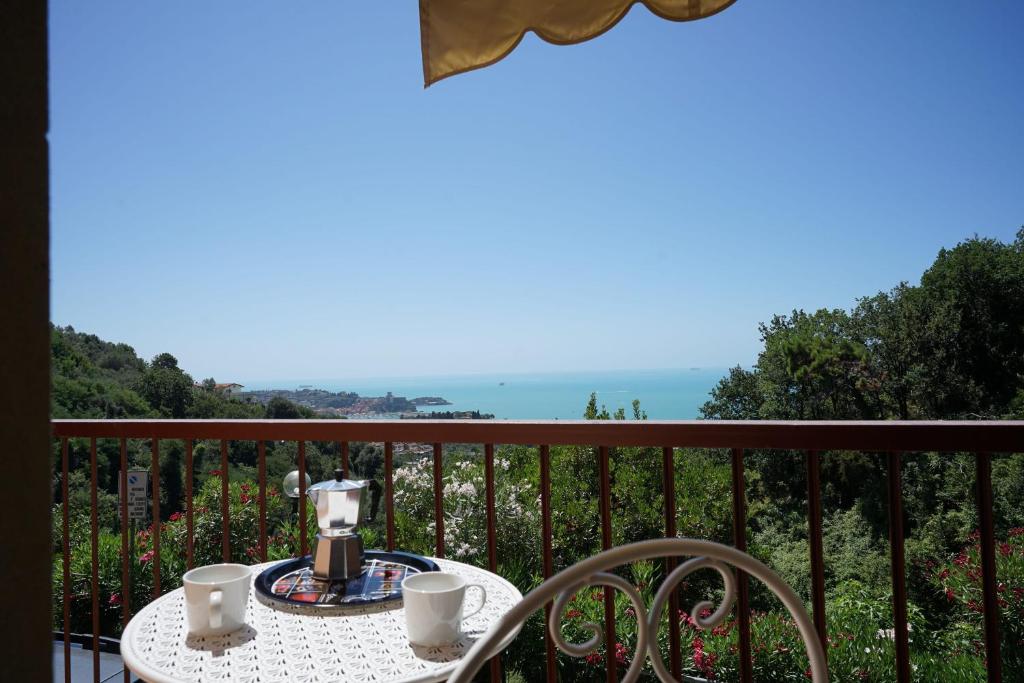 a table with a coffee maker on top of a balcony at Casa Vacanze Le Terrazze in San Terenzo
