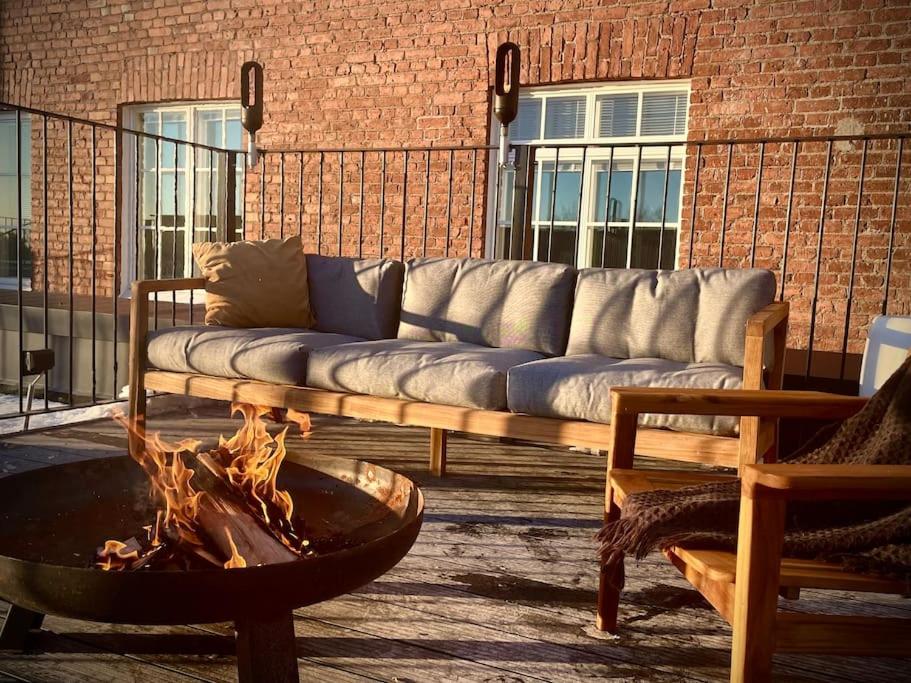 a living room with a couch and a fire pit at Stunning 90 square meter apart with 3br + rooftop in Tampere