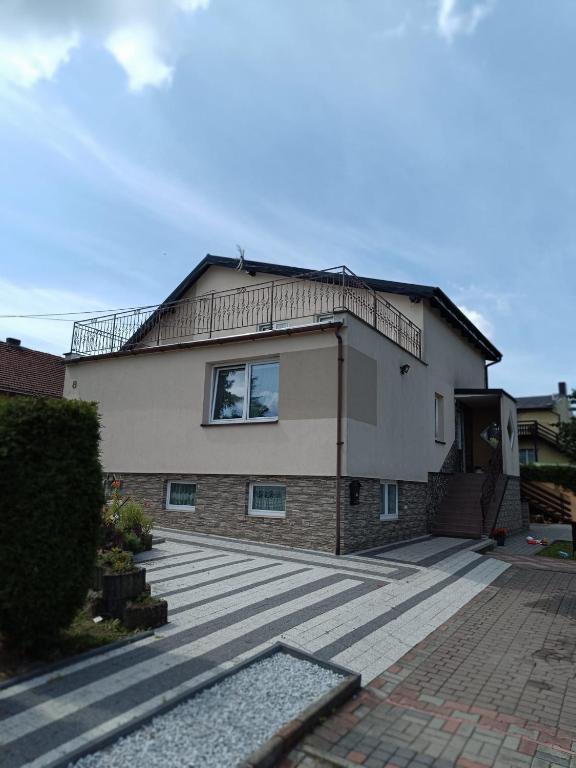 a house with a large patio in front of it at Pokoj agroturystyczny in Mieroszyno