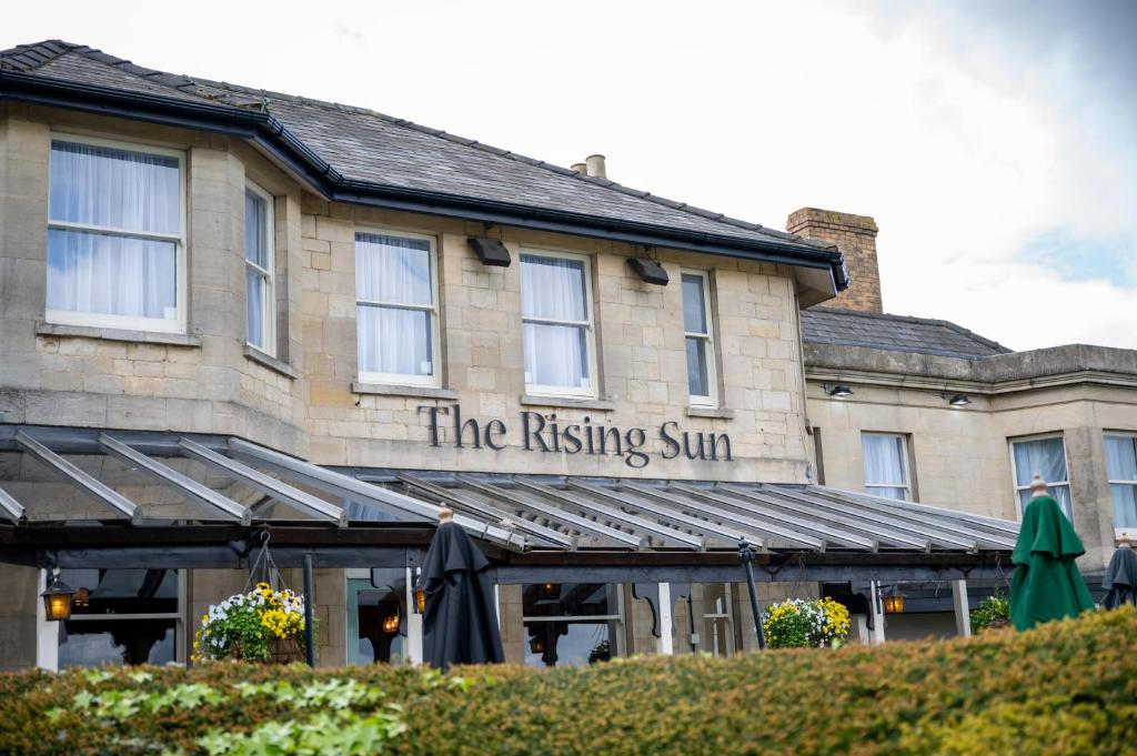 a building with the rising sun sign on it at Rising Sun Hotel by Greene King Inns in Cheltenham