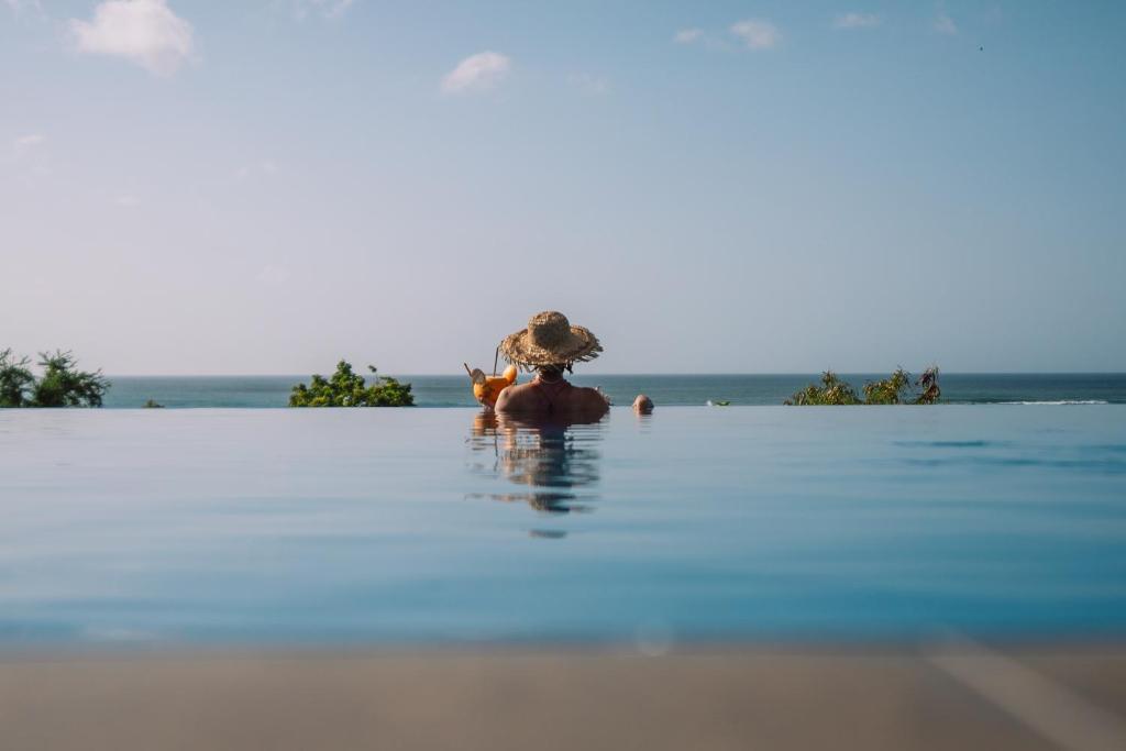 a person sitting on an elephant in the water at Ananthaya Beach in Tangalle