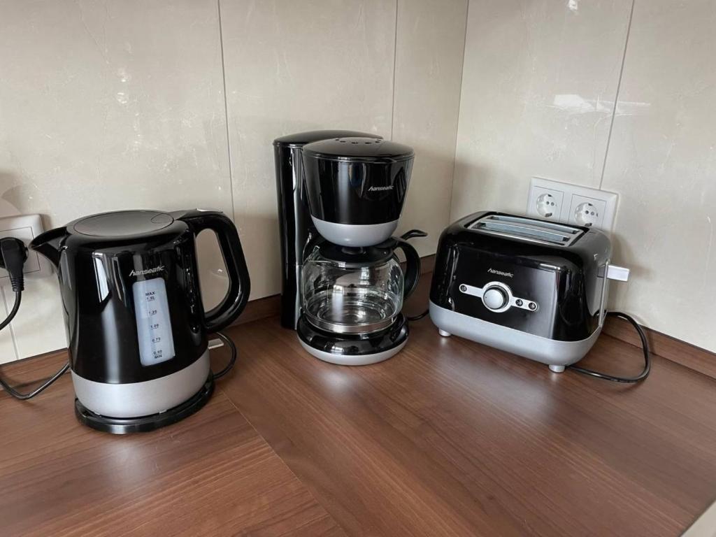 two coffee makers and a toaster on a counter at Familienfreundlichen Apartment mit traumhaft grüner Aussicht in Hamburg