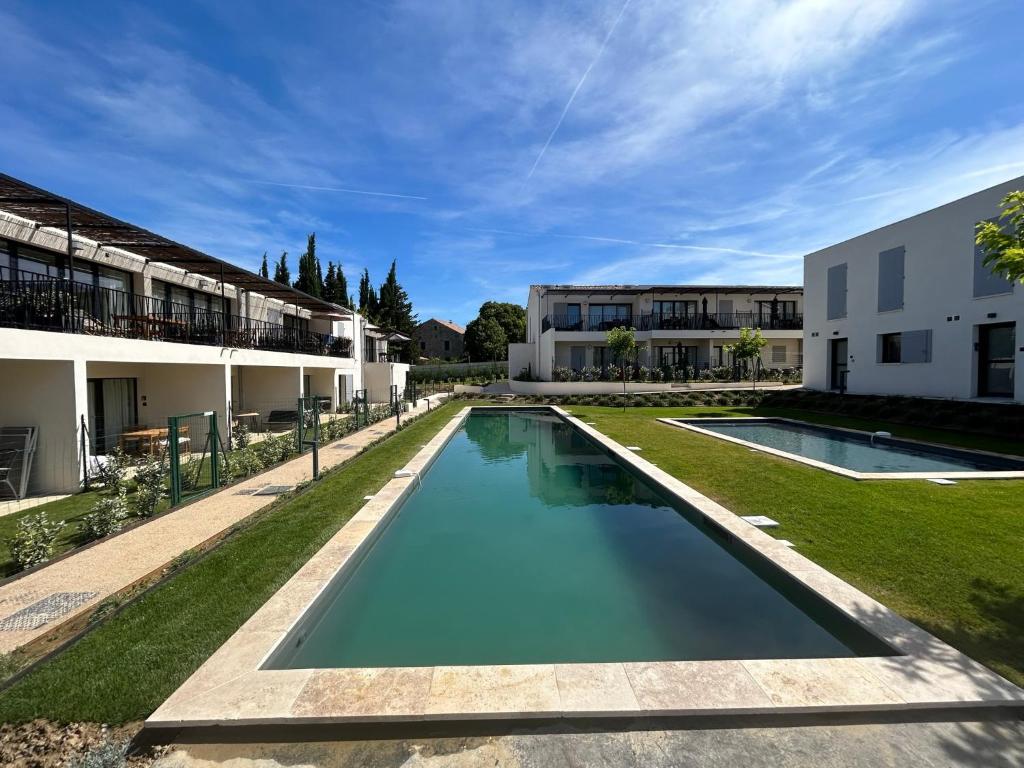 an image of a swimming pool in front of a building at Vie Ventoux in Malaucène