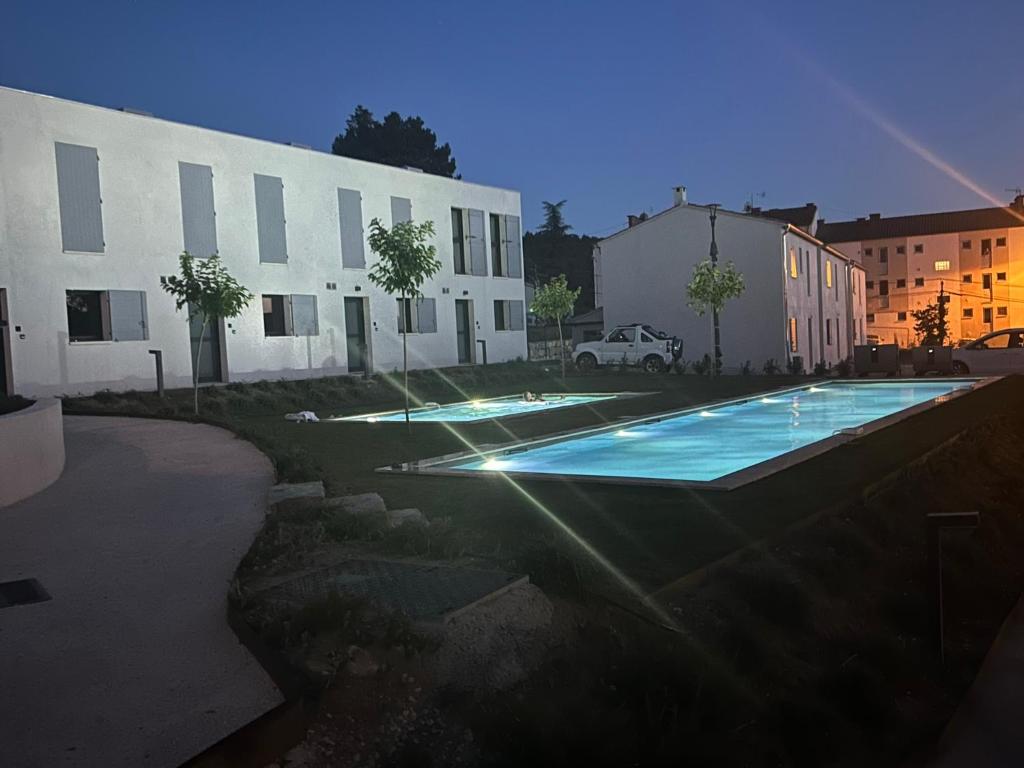 a swimming pool in a yard next to a building at Vie Ventoux in Malaucène