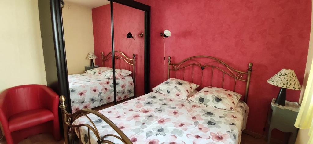 a red bedroom with a bed and a mirror at Spacieux T2 Coeur de Gap in Gap