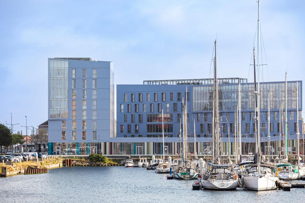 a group of boats docked in front of a building at Mercure Dunkerque Centre Gare in Dunkerque