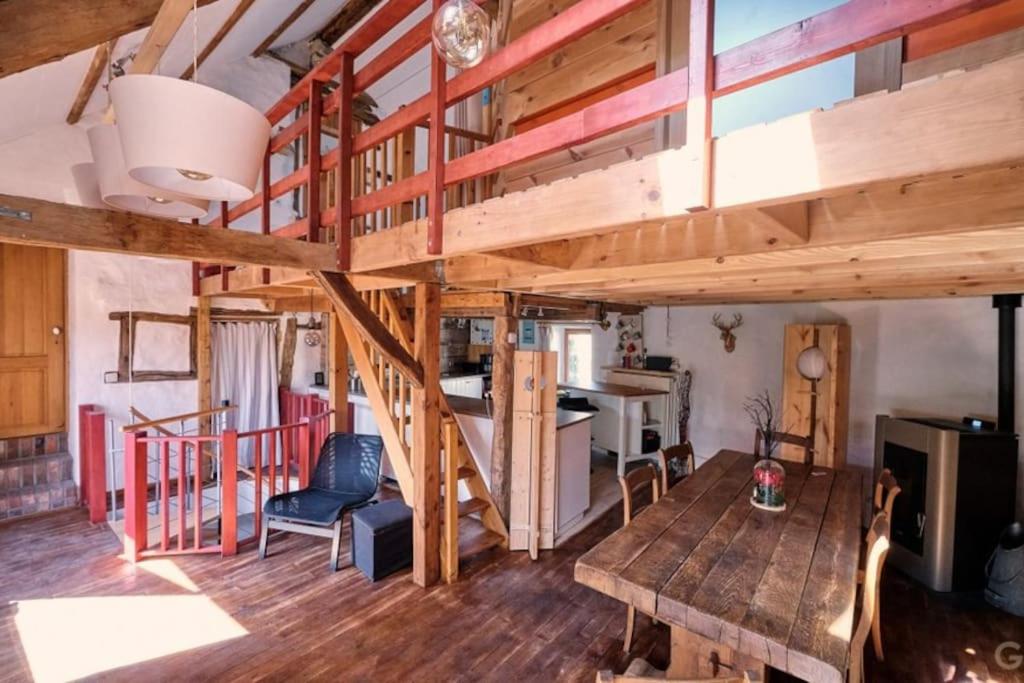Zimmer mit einem Loft mit einem Tisch und einer Küche in der Unterkunft Le Forgite - Gîte de charme in Matagne-la-Petite