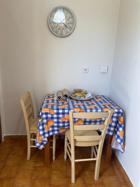 a table with a blue and white checkered table cloth at Aspasias Traditional Studio in Peroulades