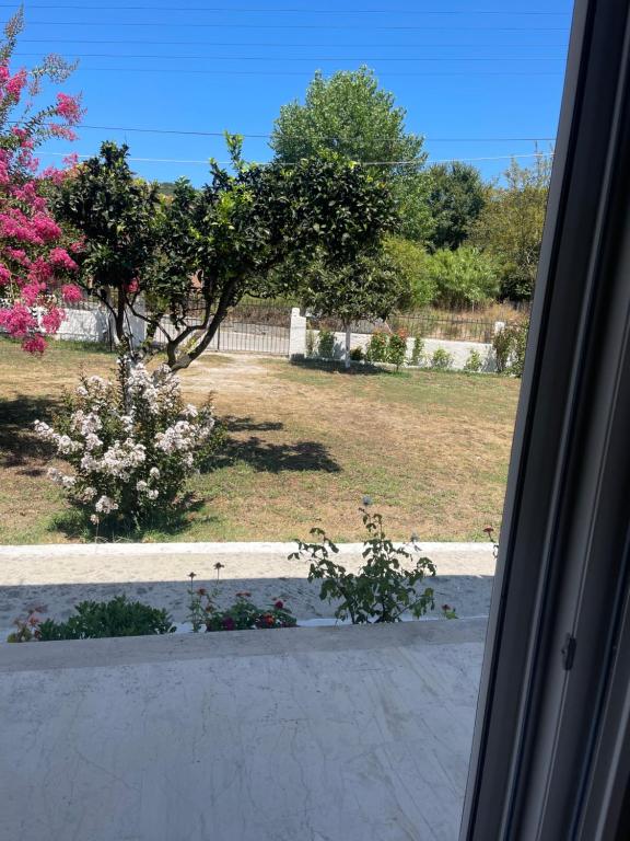 a view of a garden from a window at Aspasias Traditional Studio in Peroulades