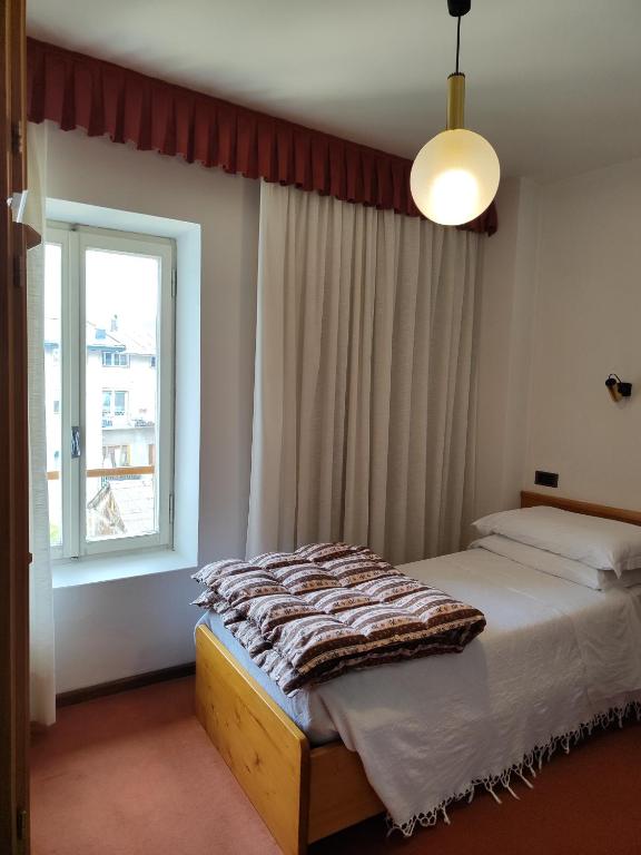 Postel nebo postele na pokoji v ubytování Al Sole Hotel Ristorante dal 1870