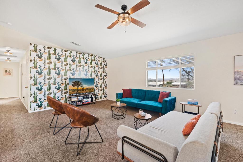 a living room with a couch and a ceiling fan at Cassia Tree in Twentynine Palms