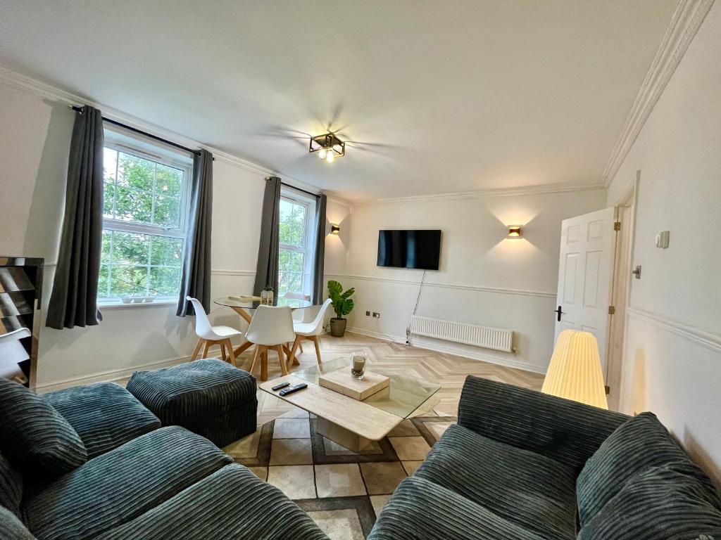 a living room with a couch and a table at Stylish Penarth Marina Apartment in Cardiff