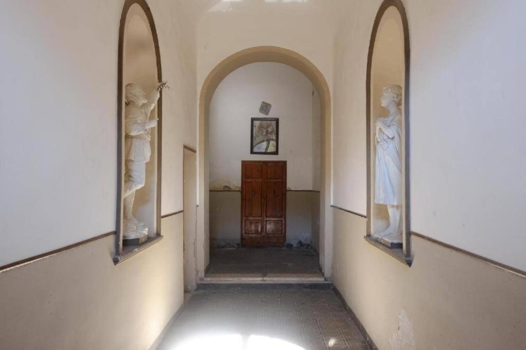 un couloir vide avec deux miroirs et une porte dans l'établissement Appartamento Centro Storico con balcone e camino - Tarquinia, à Tarquinia