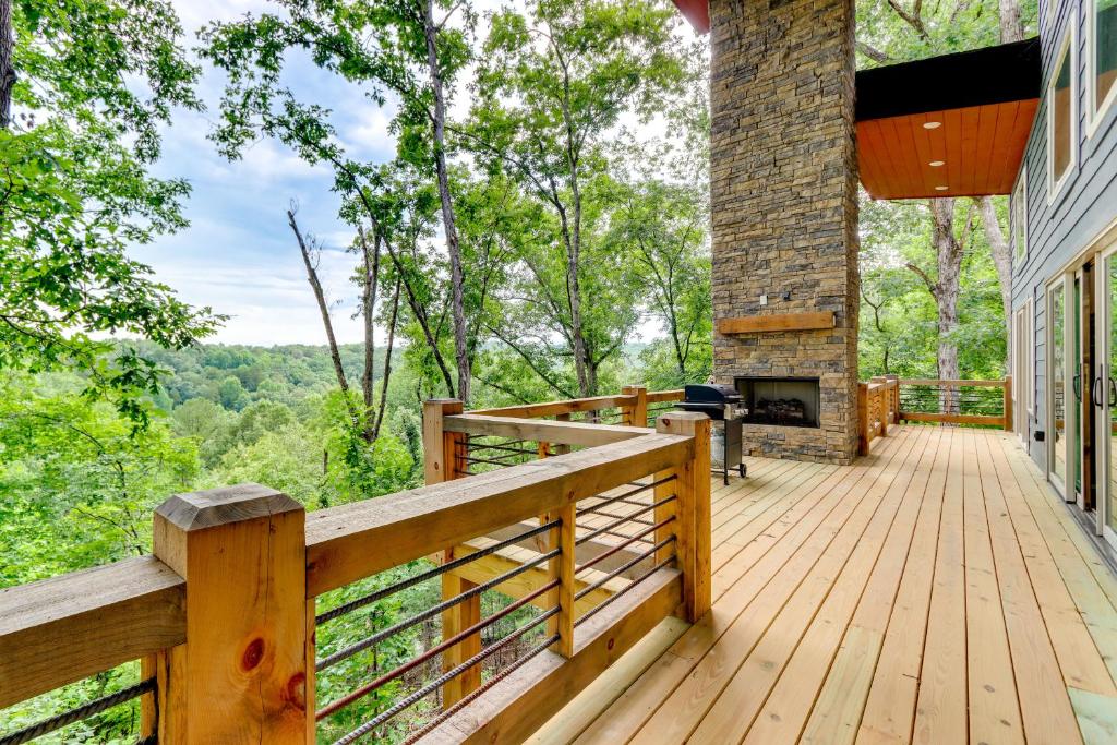 a wooden deck with a fireplace on a house at Mid-Century Modern Home with Hot Tub and Mtn Views! in Ellijay