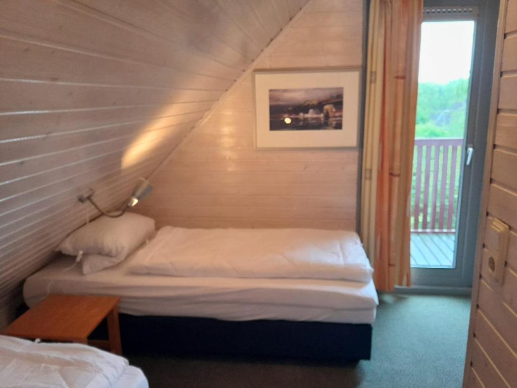 a small room with a bed and a staircase at Ferienhaus Seepark in Kirchheim in Kirchheim