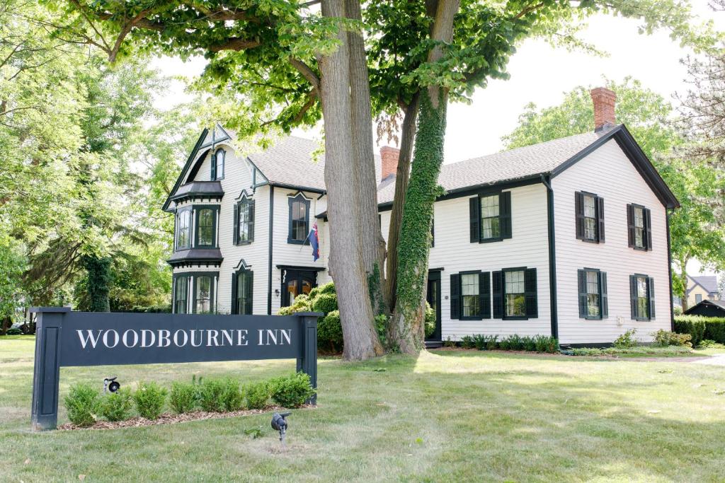 a house with a sign in front of a house at Woodbourne Inn in Niagara-on-the-Lake