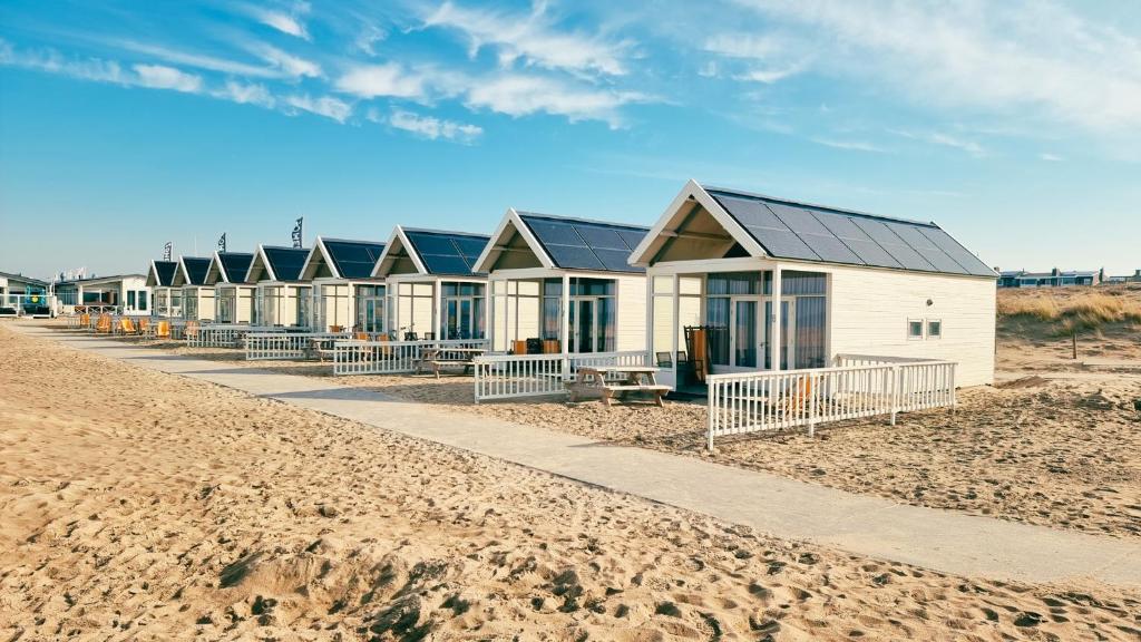 a row of beach houses on the beach at Kusthuisjes in Katwijk