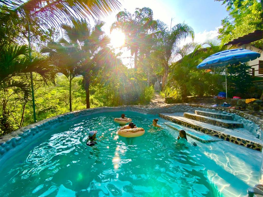 a group of people in a pool at a resort at AQUA CEIBA Hotel Spa Aventuras y Eventos in Jalcomulco